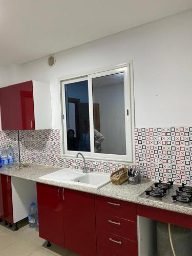 a kitchen with a sink and a mirror at Dar Frdj in Sousse