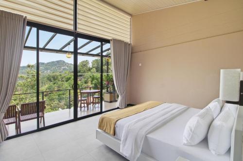 a bedroom with a bed and a large window at The Chillout Ella in Ella