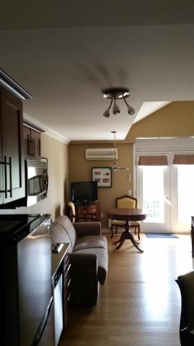 a living room with a couch and a table at Condo St Sauveur in Piedmont