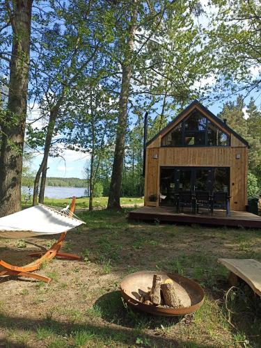 a wooden cabin in the woods with a fire pit at Domek Pod Jemiołami - Mały Głęboczek in Mały Głęboczek
