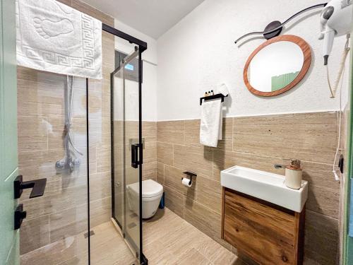 a bathroom with a toilet and a sink and a mirror at Mlinova Küçükköy in Ayvalık