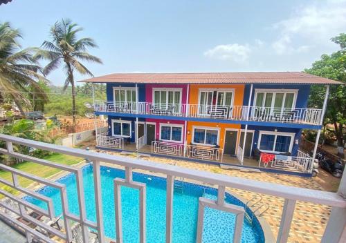 a house with a pool in front of it at Sabbia Rossa Beach Resort in Arambol