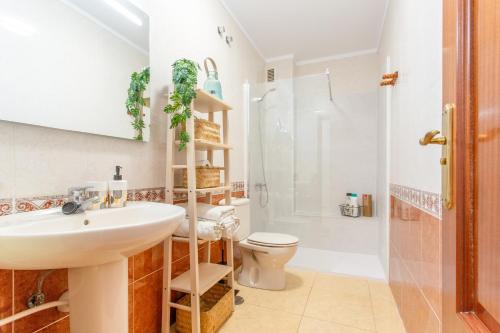 a bathroom with a sink and a toilet and a shower at Ático en Candelaria 1 in Candelaria