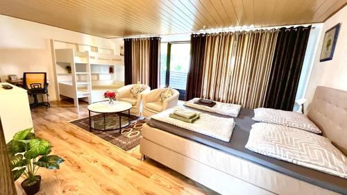 a living room with a couch and a table at Private Studio Apartment with Balcony in Dortmund-Brackel in Dortmund