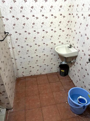 a bathroom with a sink and a toilet at SK Aarshan's Homestay in Tiruchirappalli