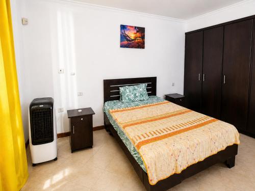 a bedroom with a bed in a room with avertisement at Solrise Villa in Palmar