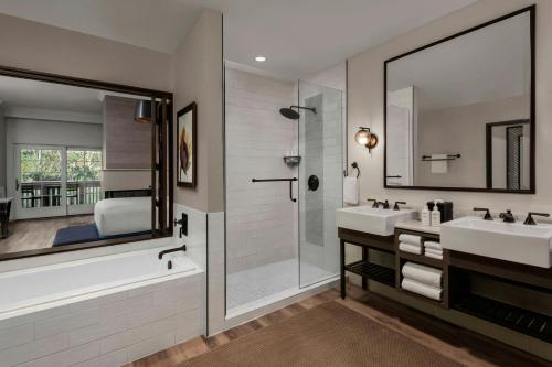 a bathroom with two sinks and a shower at River Terrace Inn in Napa