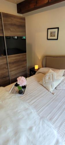 a bed with a tray with flowers on it at Ferienhaus Landidyll in Fehmarn