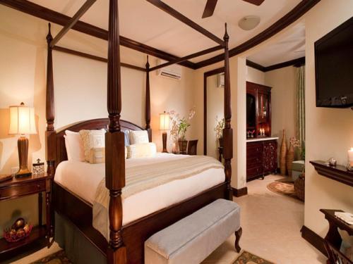 a bedroom with a large bed and a television at Sandals Negril Beach All Inclusive Resort and Spa - Couples Only in Negril