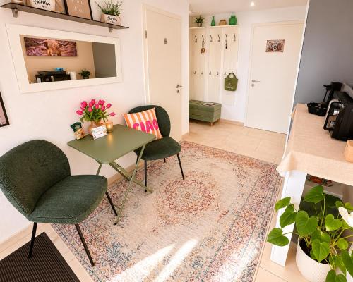 a living room with two chairs and a table at Schwarzwaldliebe mit Garten & Sauna in Gaggenau