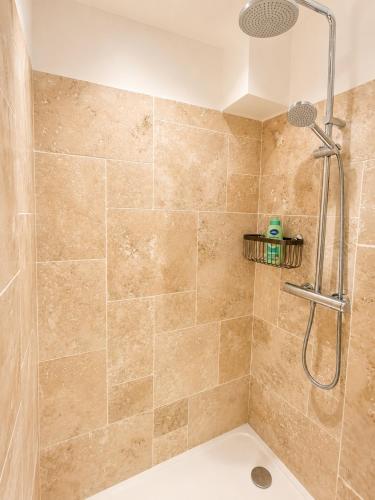 a bathroom with a shower with a shower head at " Studio Vasconia " Hyper Centre - Mezzanine -Wifi in Muret