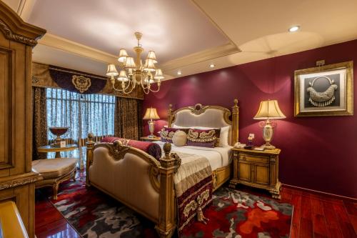a bedroom with a bed and purple walls at Tuli Imperial in Nagpur