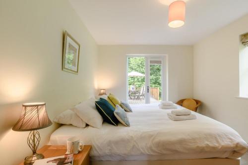 a bedroom with a large white bed with pillows at 5 Bed in Hanworth Common oc-1650 in Thurgarton