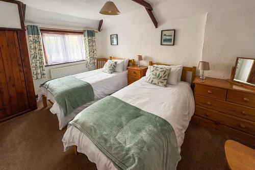a bedroom with two beds and a window at 2 Bed in Padstow oc-w3658 in Saint Merryn