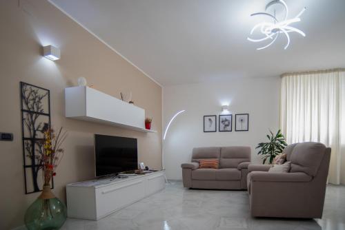 a living room with two chairs and a television at A casa di Chiara in Lecce