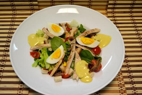 a white plate with a salad with eggs on it at Park House in Dej