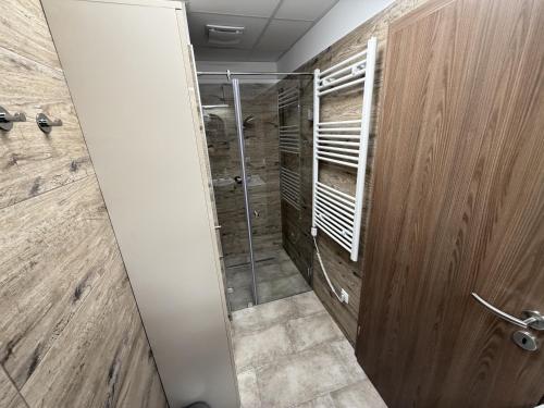 ein Badezimmer mit Dusche mit Glastür in der Unterkunft Noir Hotel in Szeged