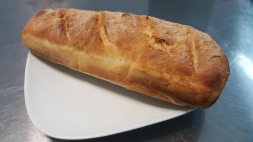 a loaf of bread sitting on a white plate at Park House in Dej