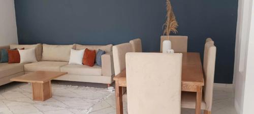 a living room with a couch and a table at Apartement Rimsou in Kelibia