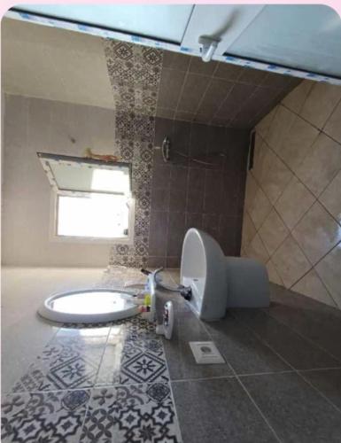 a bathroom with a toilet and a sink in it at Apartement Rimsou in Kelibia
