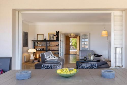 a living room with a bowl of fruit on a table at Villa Bollaccia - piscine privée proche de la mer in Aregno