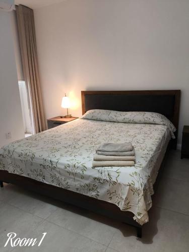 a bedroom with a bed with towels on it at Link Point -Private room in shared Apartment in Misraħ Il-Barrieri