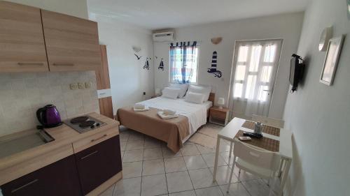 a small room with a bed and a kitchen at Budget Holiday Apartments Primorska in Pag