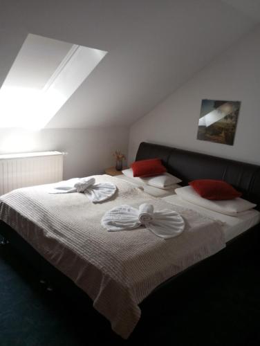 a bedroom with a bed with towels on it at Hotel Al Cavallino in Arnstorf
