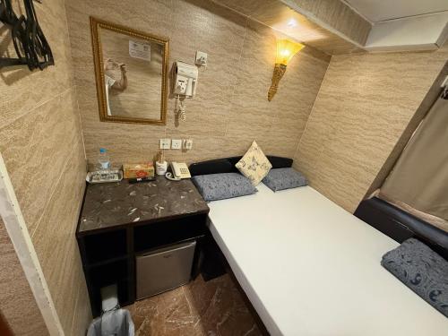a small room with a bed in a trailer at Sleep Inn in Hong Kong