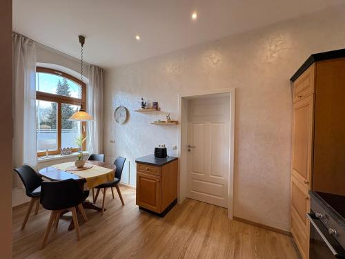 a kitchen with a table and a dining room at Ferienwohnungen Landeskrone Dresden in Dresden