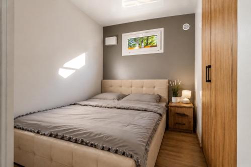 a bedroom with a bed and a wall with skylights at Domki Na Talerzu in Skorochow