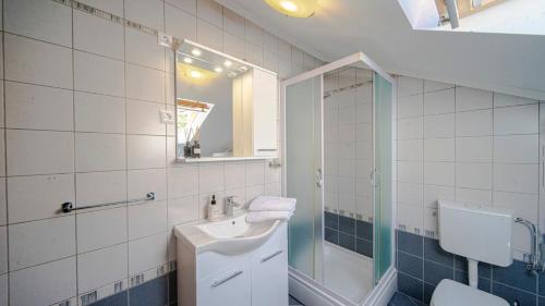 a bathroom with a sink and a shower and a toilet at Apartman Mario with pool by Villas Guide in Blato