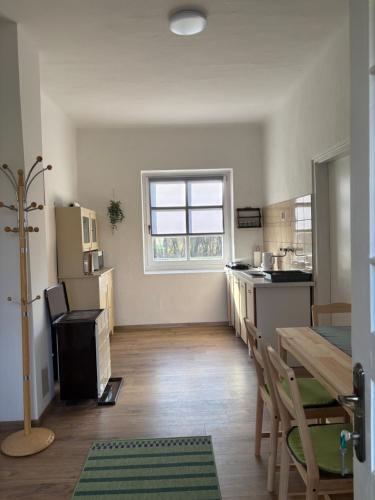 a kitchen with a table and a dining room at Tornácos Vendégház in Szécsény