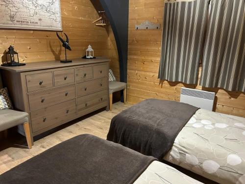 a bedroom with a bed and a dresser at Chalet Isard in Gère-Belesten
