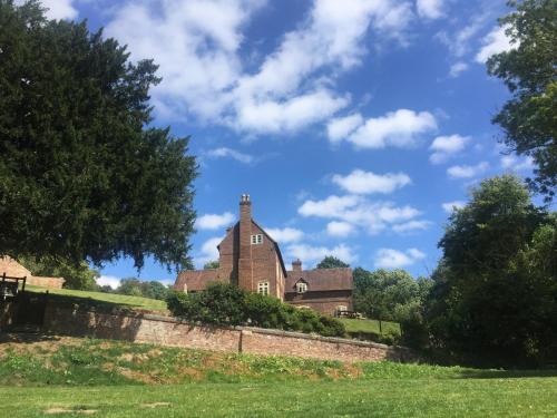 an old house on top of a hill at Worralls Grove Guest Farm House in Bewdley