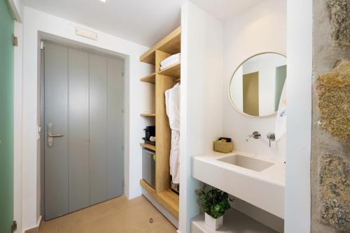 a bathroom with a sink and a mirror at Aegean Hospitality in Mikonos