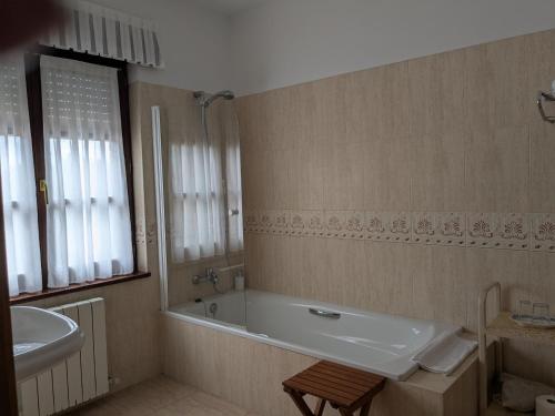 a bathroom with a bath tub and a sink at Posada La Merced in Loredo