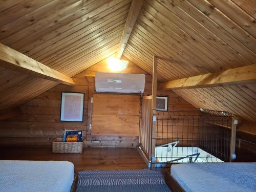 a attic room with a wooden ceiling and two beds at Quinta do Benjamim - Tejo "For 2, family, nature or relax" in Praia do Ribatejo