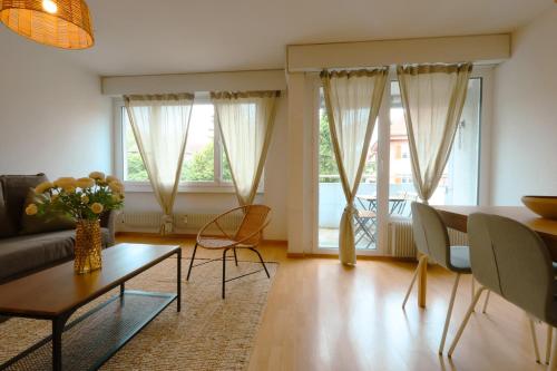 a living room with a couch and a table at Cozy Apartment with Easy Access to Bern in Bern