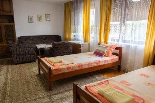 a living room with two beds and a couch at Apartment Bojke in Niš