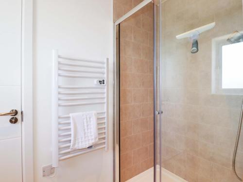 a bathroom with a shower with a glass door at Eden's Bloomdale in St Austell