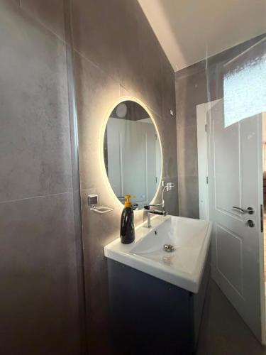 a bathroom with a white sink and a mirror at The Canyon House in Çuadar