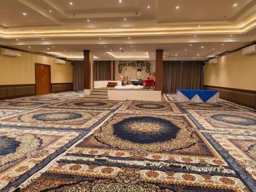 a large room with a large rug on the floor at Northern Residency in Srinagar