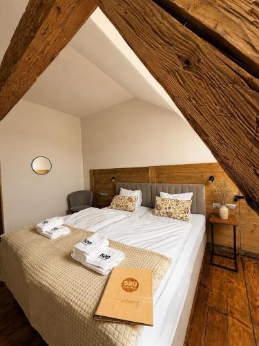 a bedroom with a large bed in an attic at Gospoda Dębowiec520 in Bielsko-Biała