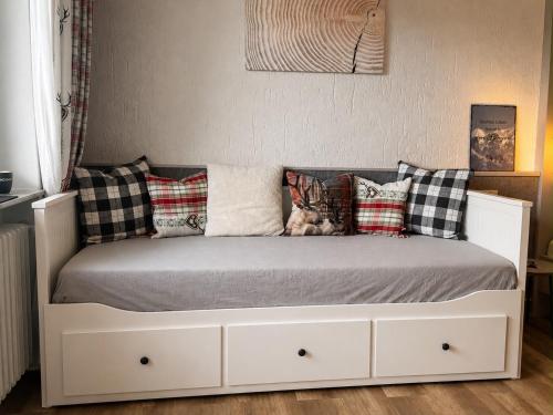 a white bed with pillows on it in a bedroom at Ferienwohnung Darosa Alpenliebe in Seeg