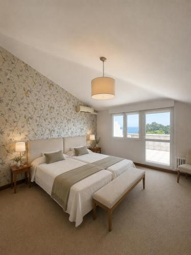 a bedroom with a large bed and a large window at Hotel Arresi in Arminza