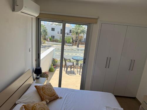 a bedroom with a bed and a view of a patio at 777 Stars in Paphos