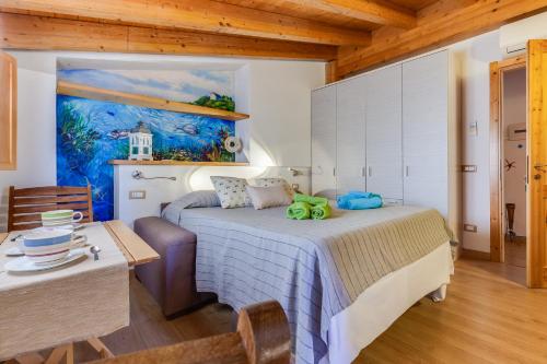 a bedroom with a bed and a painting on the wall at Blue Horizon Stintino in Stintino