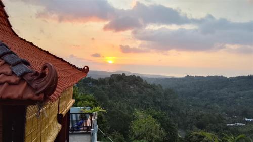 a view of the sunset from a house at Mayong Awan Cita in Munduk