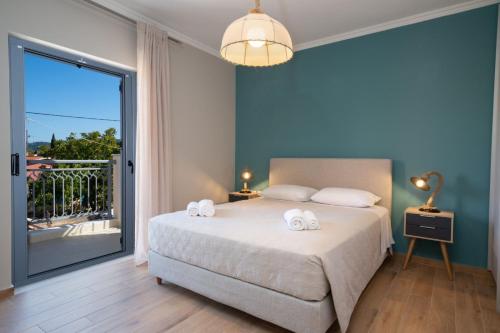 a bedroom with a bed with two towels on it at K for Kefalonia in Karavomylos